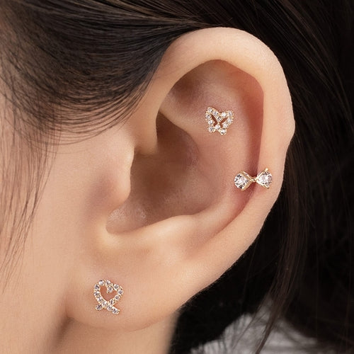 Solid gold cubic bow piercing